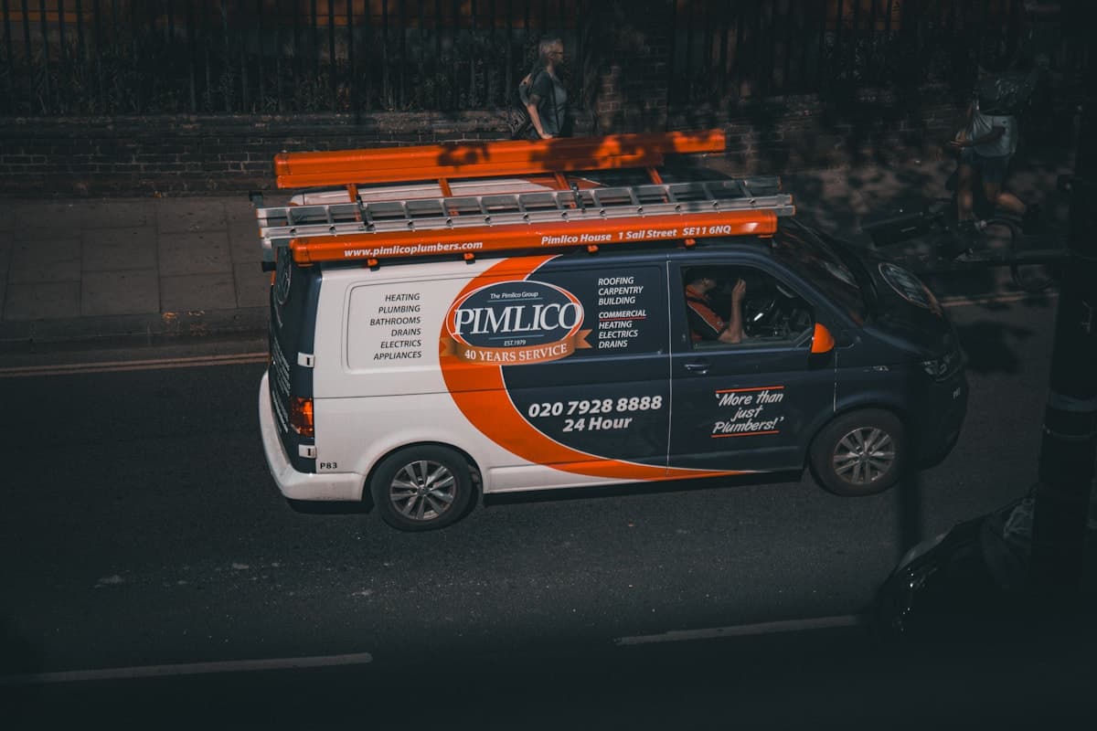 A white work van with bold logo branding, the rolling billboard that drives repeat referrals.